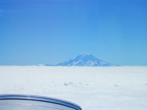 Mount Rainier comes up through the undercast